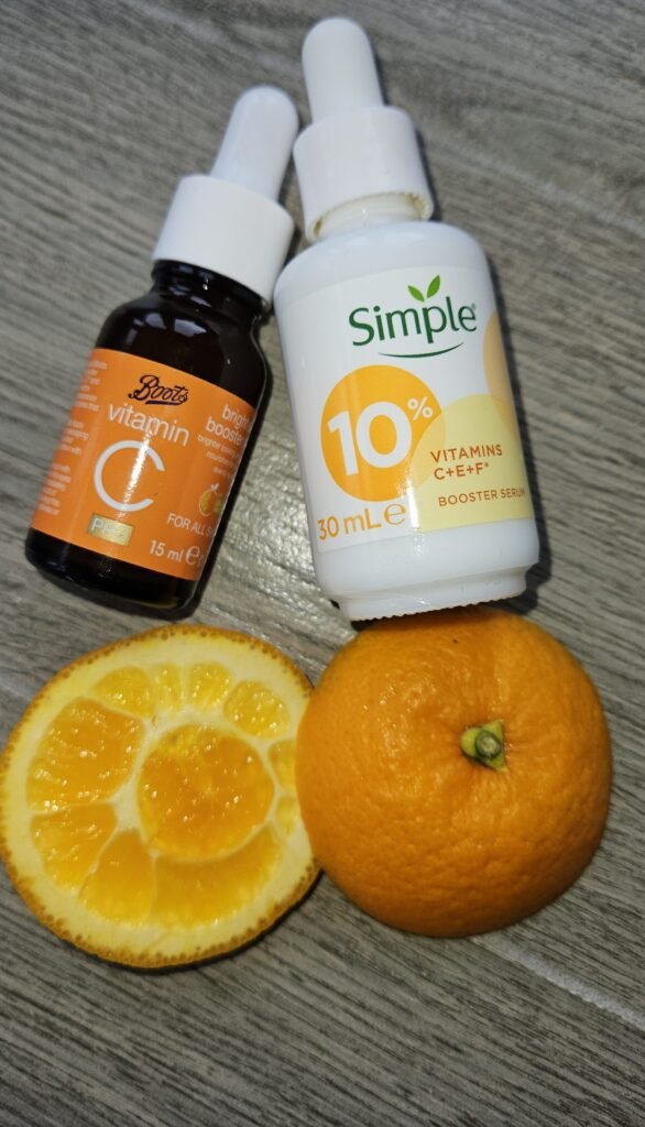 Vitamin C serums with a freshly cut orange