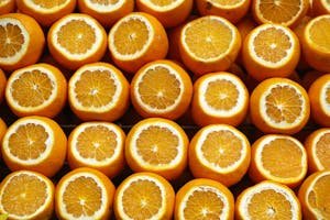 A vibrant array of freshly cut oranges showcasing their juicy interior. Perfect for healthy lifestyle themes.